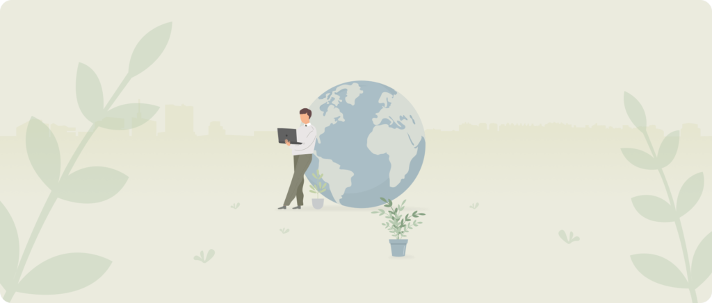 A man with a laptop leans against a globe.
